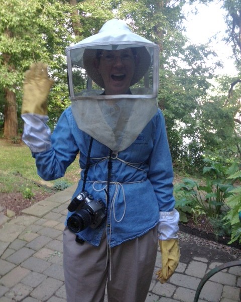 Kate St. John in beekeeping gear (photo by Joan Guerin)