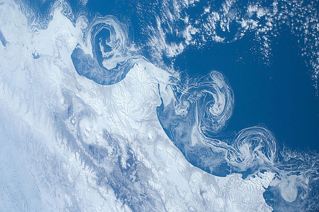 Ice flows off the Kamchatka coast (photo from the International Space Station via Wikimedia Commons)