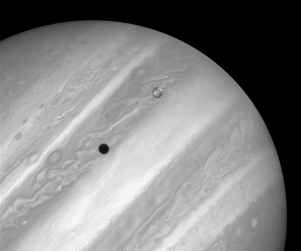 Io with its shadow on Jupiter (image from Wikimedia Commons)