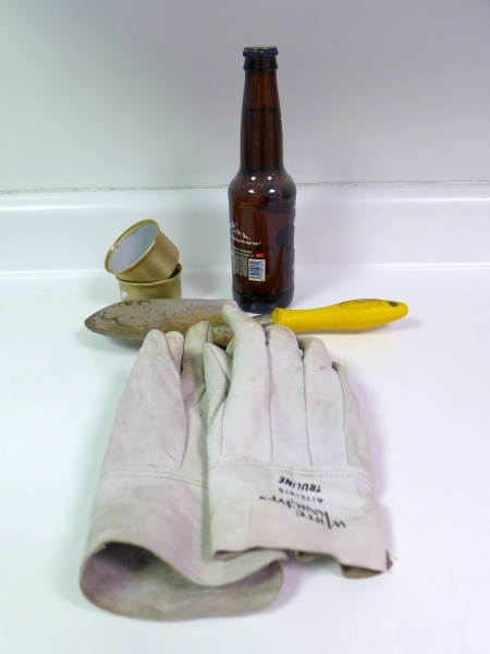 Slugfest tools: beer, small catfood cans, trowel, garden gloves (photo by Kate St. John)