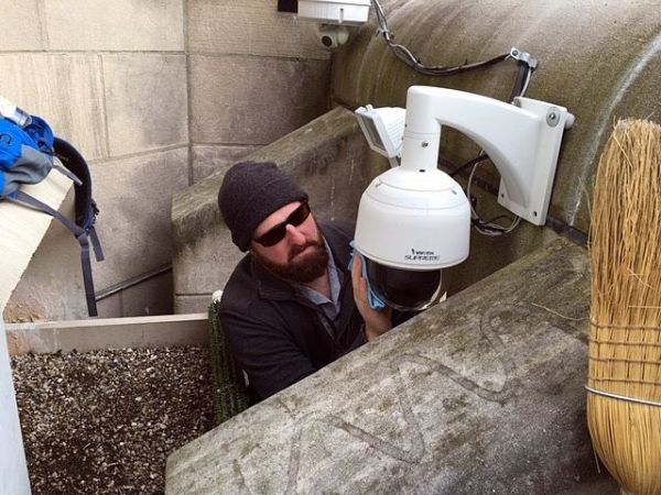 Jason cleans the webcam's protective dome (photo courtesy Bob Mulvihill, National Aviary)