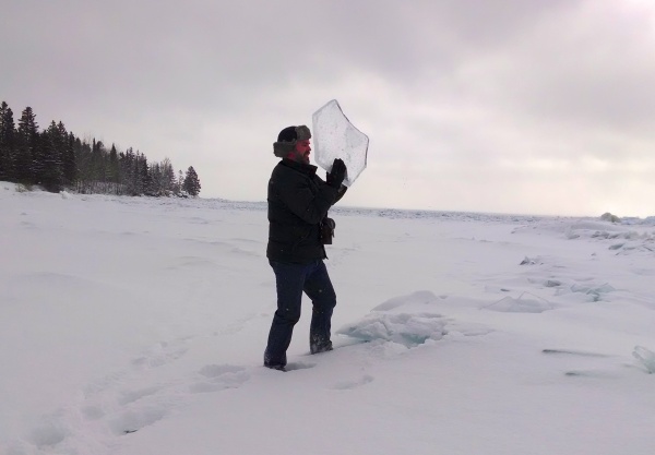 Man holding ice chard from Lake Superior (photo by Kate St. John)